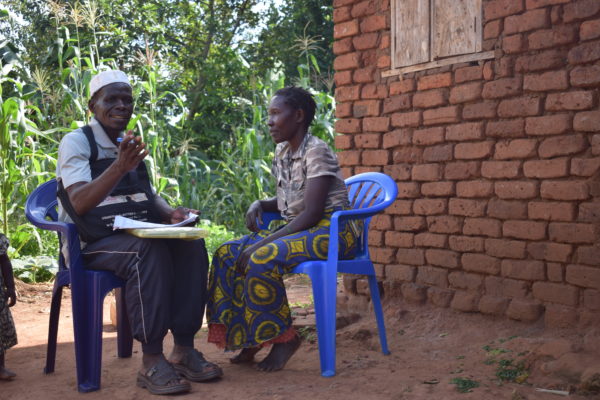 Swaib - Community Case Worker in Uganda talks with a community member.