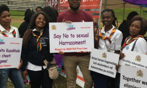 Mbonisi Tshuma, WEI/Bantwana Malawi Team Lead, poses with campaign participants at the launch of the 16 Days of Activism in Malawi.